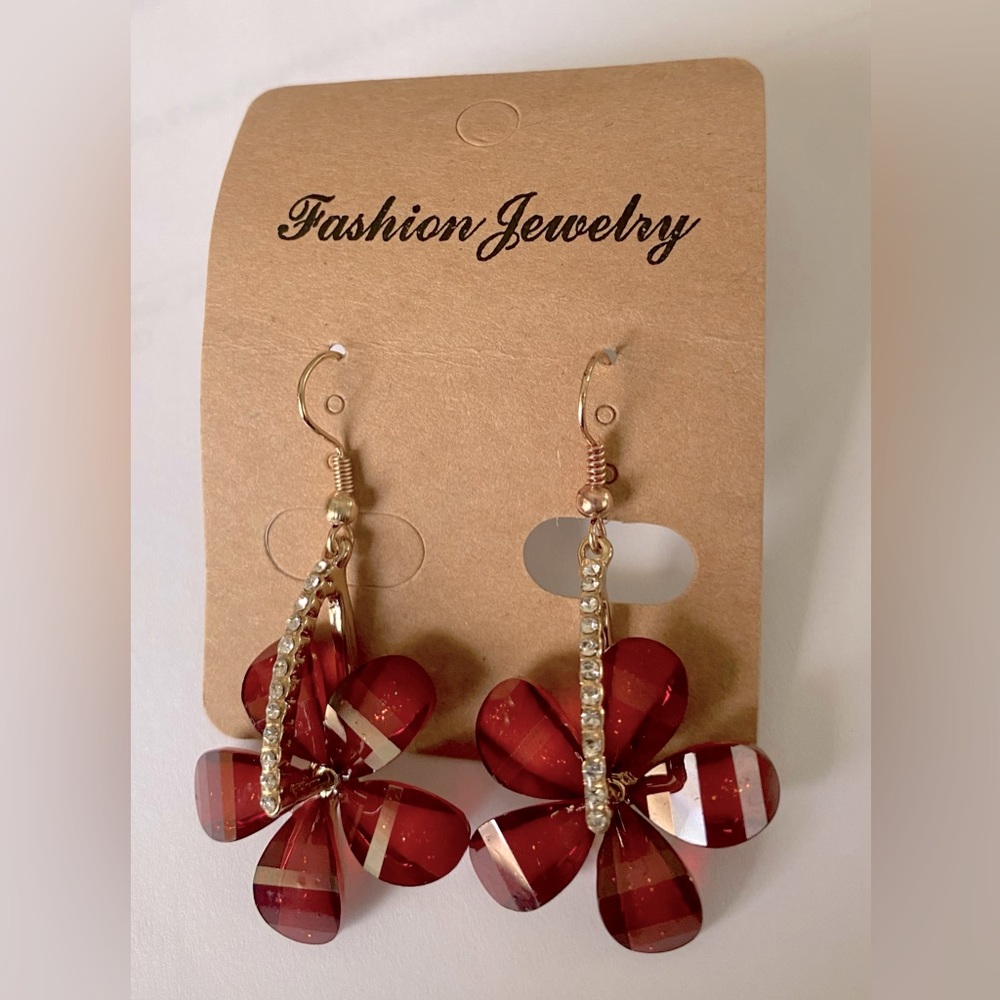 Red flower earrings with cubic zirconia stems.